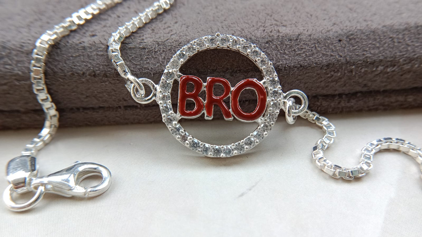 Silver bracelet with a round charm displaying the word 'BRO' as rakhi