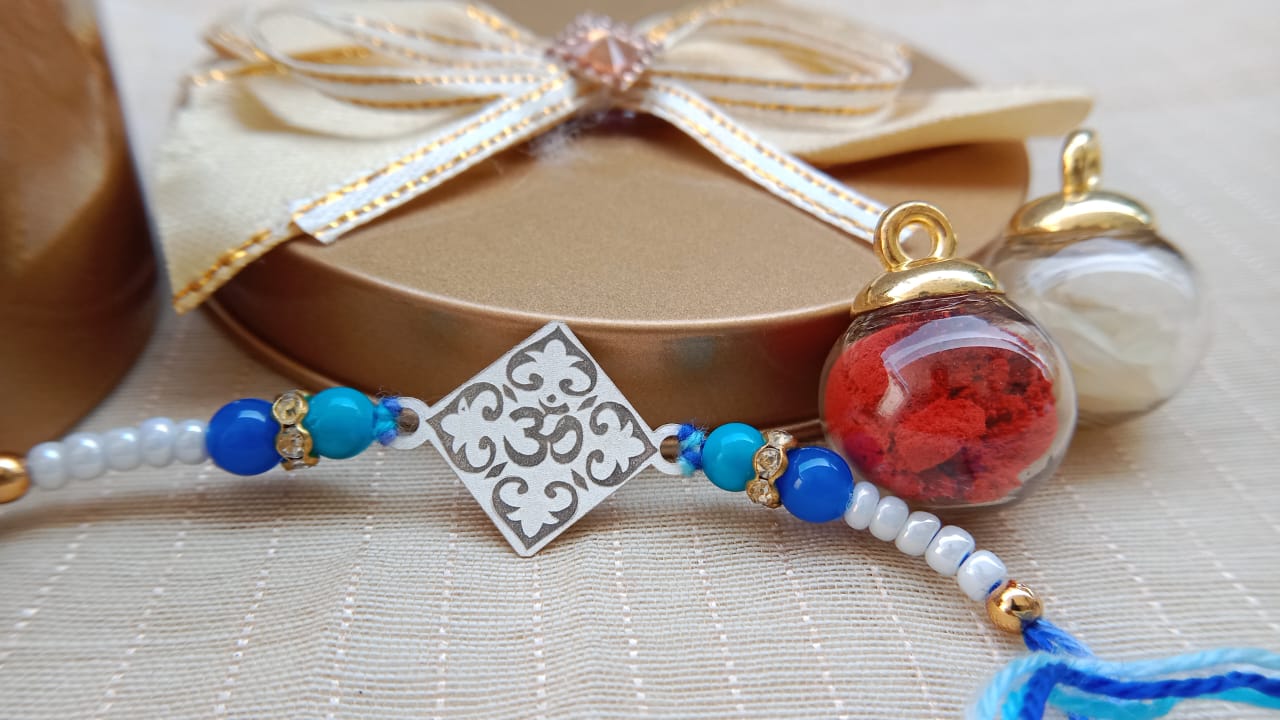925 Pure Silver Om Rakhi with Blue & White Beads | Aryanz