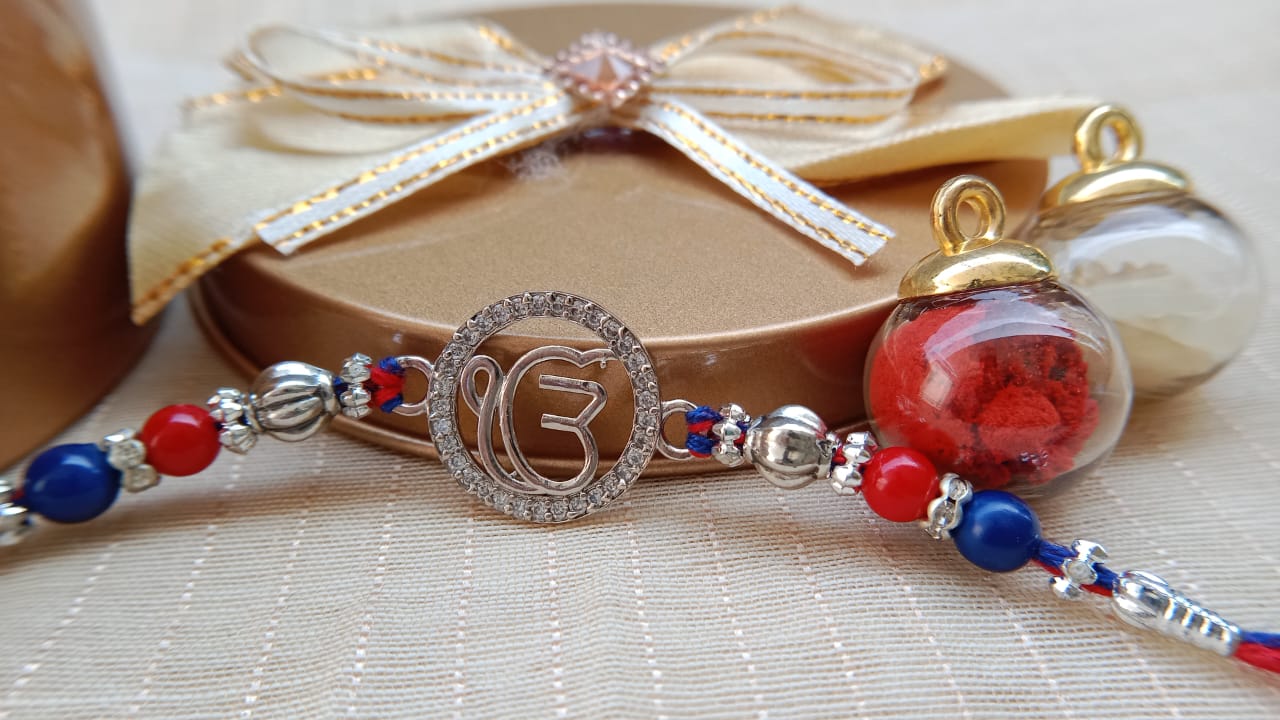 925 Silver EK OmKar Rakhi with Red Blue Beads & Clear Stone Detail