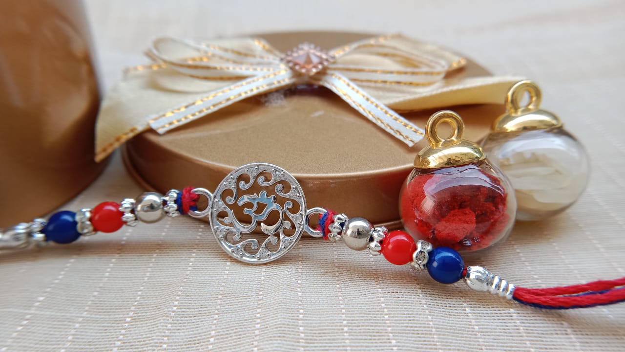 Designer Om Rakhi with Red & Blue Beads | Aryanz Jewellery