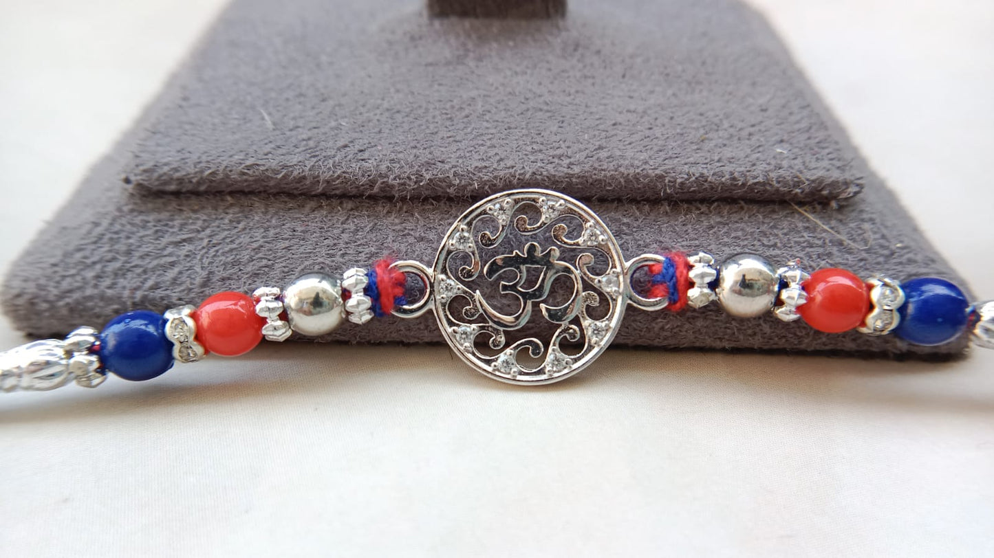 Designer Om Rakhi with Red & Blue Beads | Aryanz Jewellery